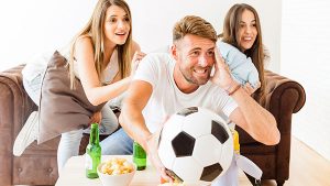 Young adults watching a soccer game in student housing