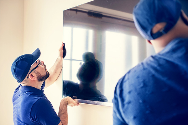 TV Installation performed by two men.