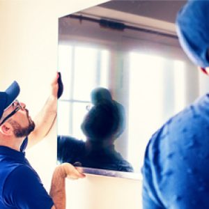 Two men doing a TV Installation