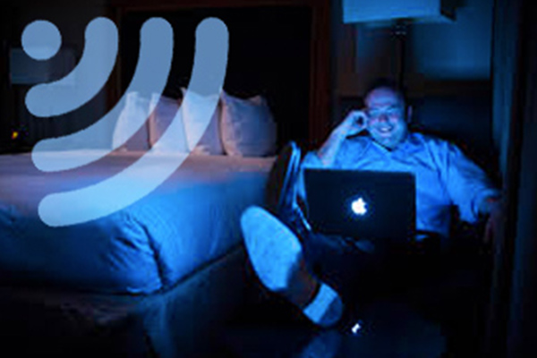 A man using Business Internet on his laptop in a hotel room